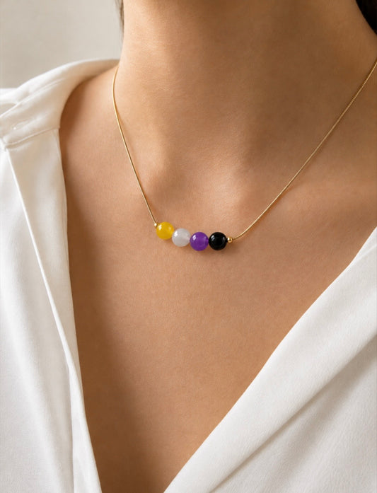 The Alignment Non-Binary Necklace worn around the neck on a white top — minimalist LGBTQ+ pride jewelry