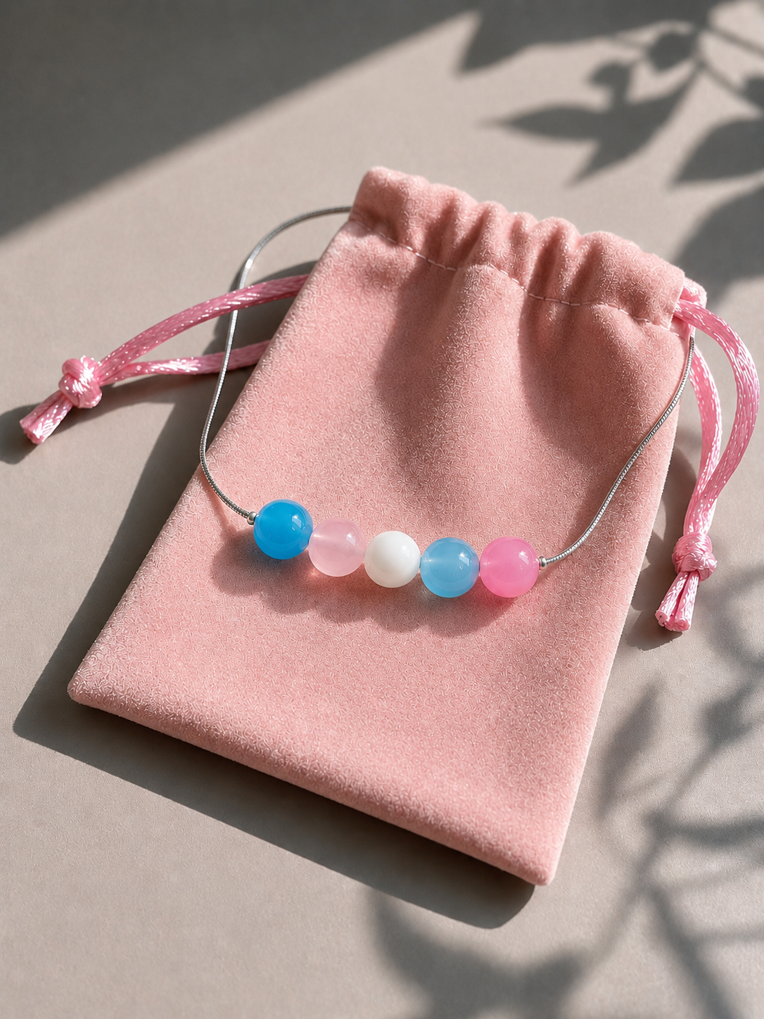 The Alignment Trans Pride Necklace presented in a pink velvet gift pouch — LOUD SOULS jewelry packaging