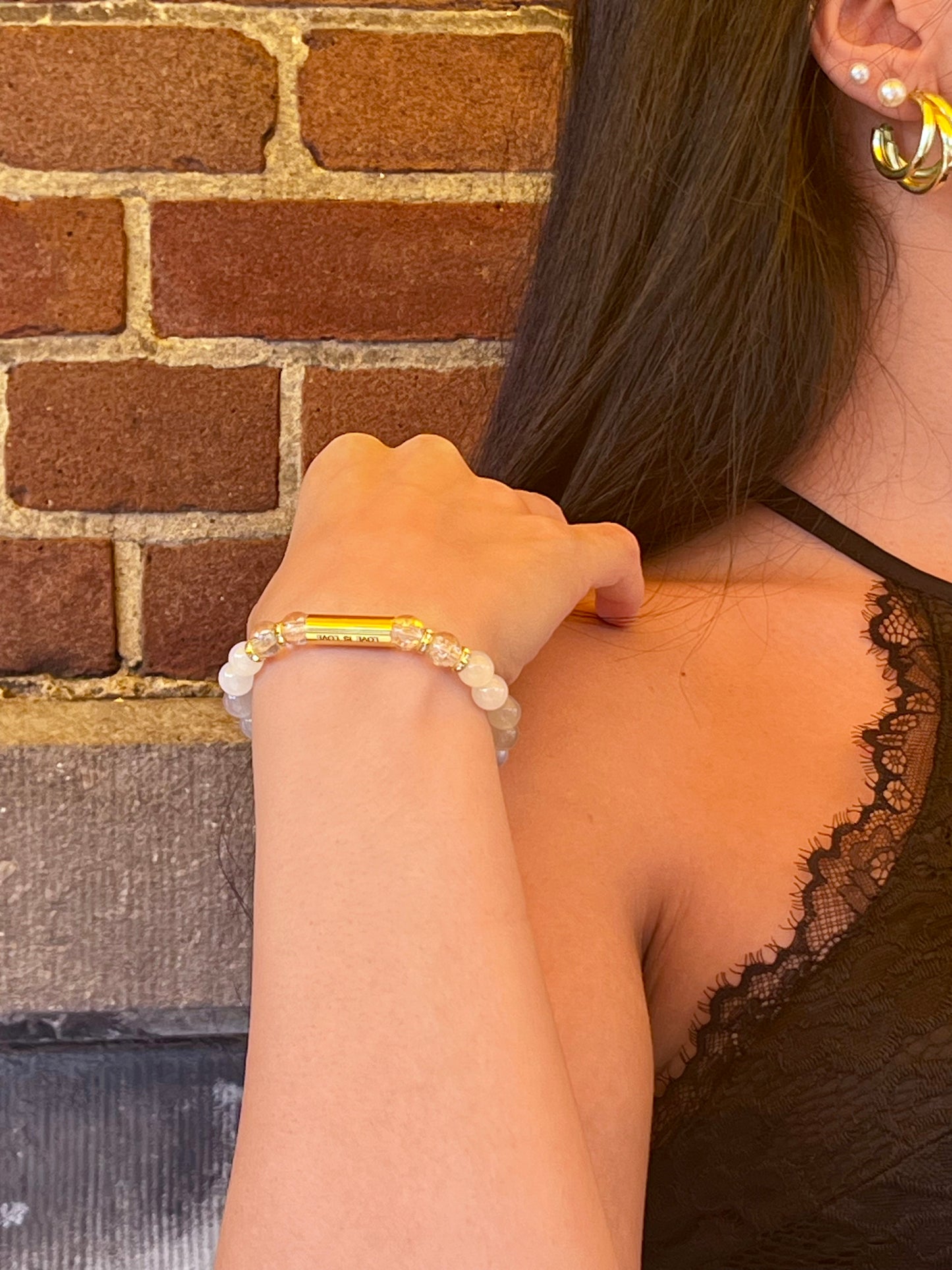 Detail shot of Love Is Love Bracelet showing gold spacer beads and stretch fit design