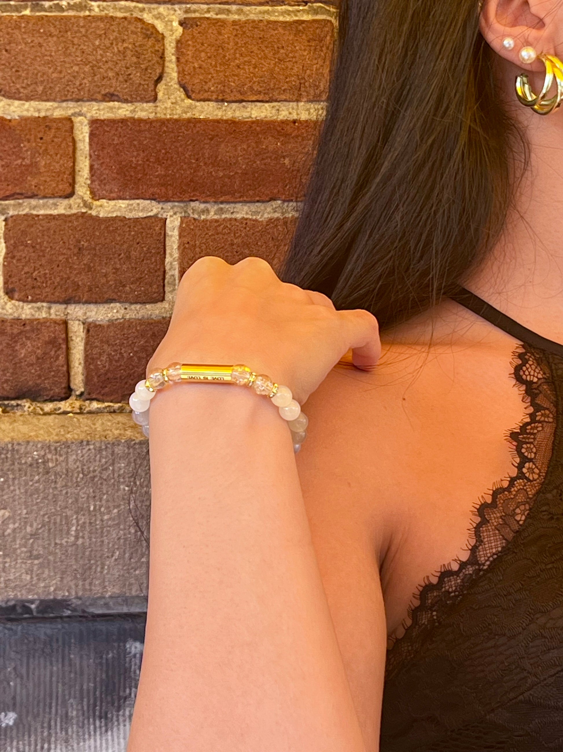Detail shot of Love Is Love Bracelet showing gold spacer beads and stretch fit design