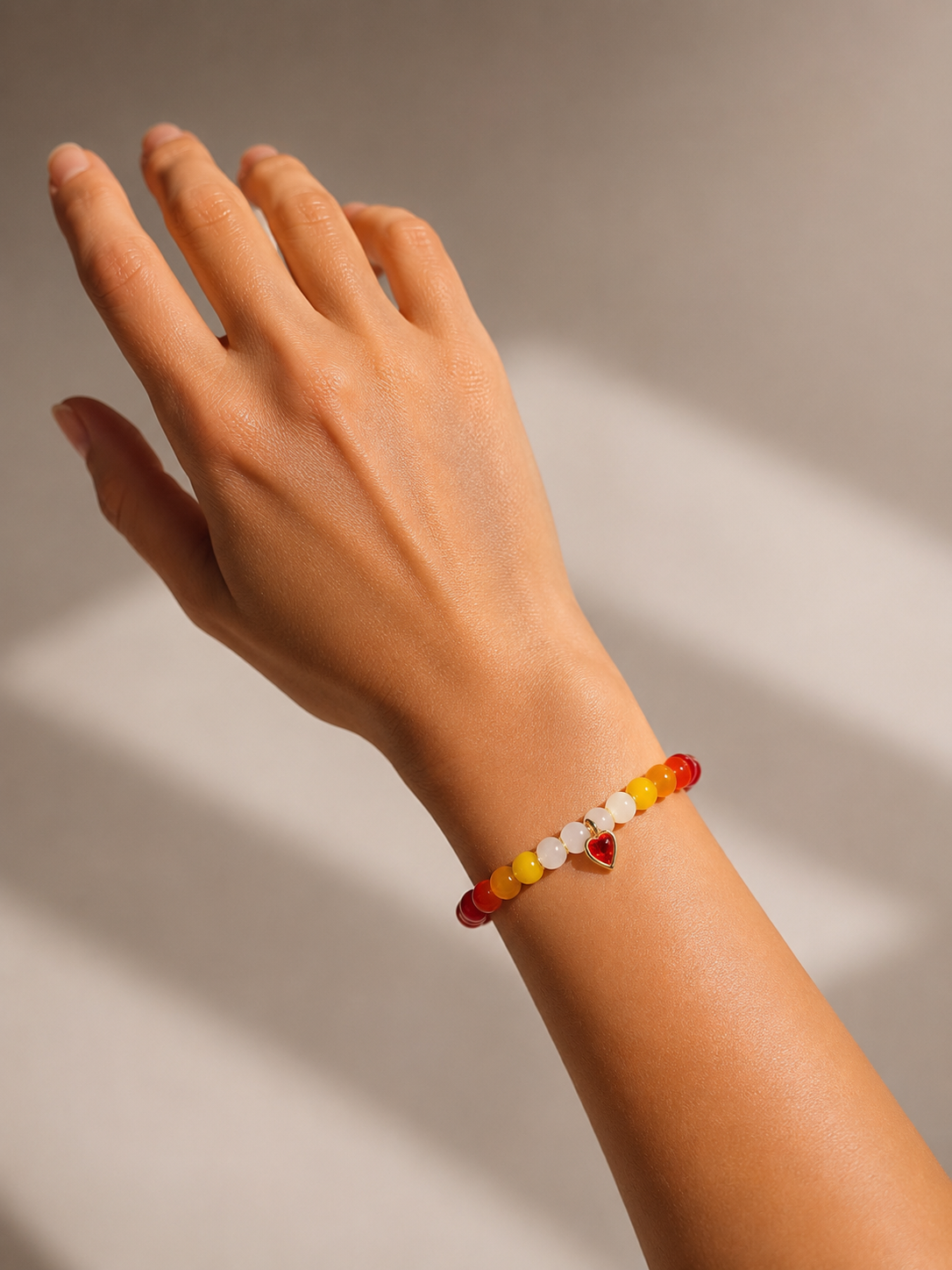 Sunset Heart Bracelet worn on wrist — handmade LGBTQ+ lesbian pride jewelry